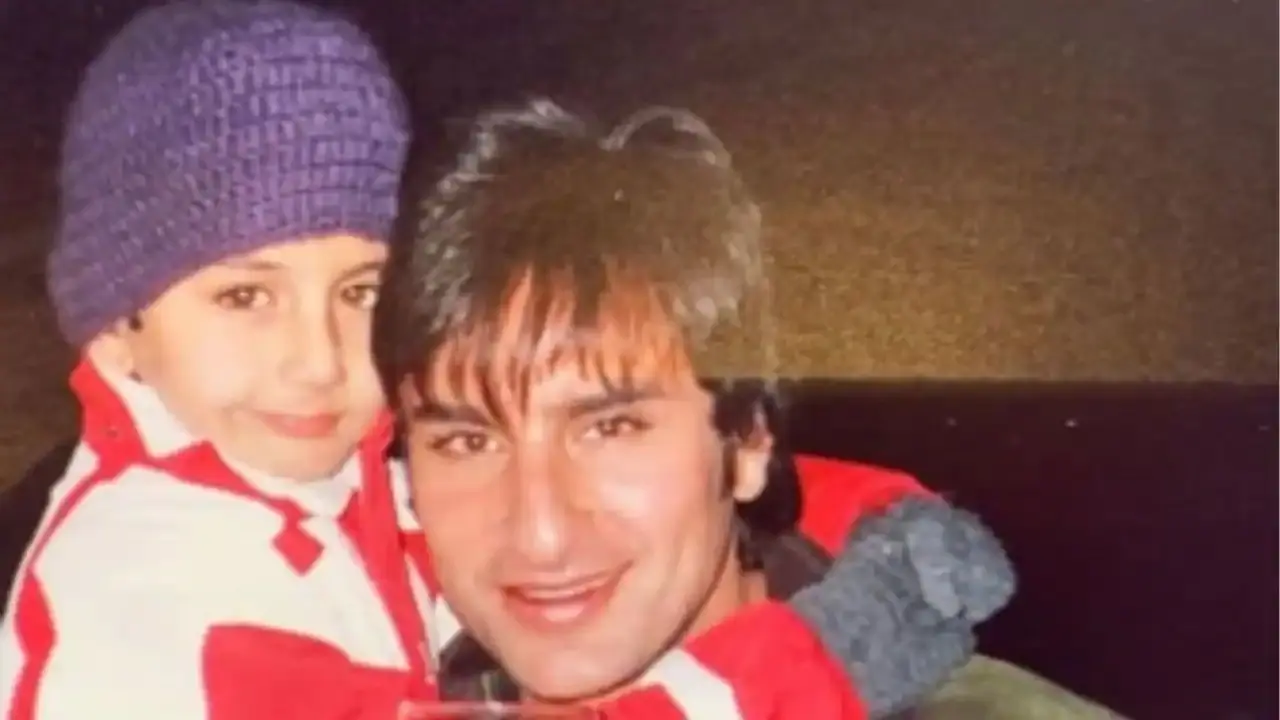 Ibrahim clings to daddy dearest as Saif carries him in his arms.